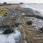 
              FILE - Contractors for the U.S. Army Corps of Engineers pump sand from the ocean floor onto the beach in the Rockaway Peninsula in New York City on, Oct. 18, 2022. They are crafting a 250-foot wide sandy beach along more than seven miles of shoreline to help protect the city from storms and rising sea levels. Secretary-General Antonio Guterres warned Tuesday, Feb. 14, 2023, that even if global warming is "miraculously" limited to 1.5 degrees Celsius (2.7 degrees Fahrenheit), there will still be a sizable sea level rise. (AP Photo/Ted Shaffrey, File)
            