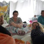 
              Maeleene Jessop, a former member of The Fundamentalist Church of Jesus Christ of Latter-Day Saints, a polygamist offshoot of the Mormon church, second from left, talks with her fellow participants before the third and final ayahuasca ceremony during a retreat hosted by the Hummingbird Church, in Hildale, Utah, on Sunday, Oct. 16, 2022. Hummingbird is part of a growing global trend in which people are turning to ayahuasca to treat an array of health problems after conventional medications and therapy failed them. (AP Photo/Jessie Wardarski).
            