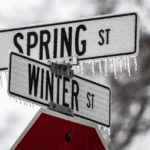 
              Freezing rain coats road signs for Winter and Spring streets in Spring Lake, Mich., on Monday, Feb. 27, 2023. (Cory Morse/MLive.com/The Grand Rapids Press via AP)
            