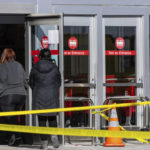 
              Customers enter so they can retrieve their belongings on Wednesday, Feb. 1, 2023, a day after they fled the Target store after someone walked in and started firing an assault rifle. Omaha police shot and killed the suspect. (Chris Machian/Omaha World-Herald via AP)
            