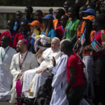 
              Pope Francis meets with a group of the Catholic faithful from the town of Rumbek, who had walked for more than a week to reach the capital, after he addressed clergy at the St. Theresa Cathedral in Juba, South Sudan, Saturday, Feb. 4, 2023. Pope Francis is in South Sudan on the second leg of a six-day trip that started in Congo, hoping to bring comfort and encouragement to two countries that have been riven by poverty, conflicts and what he calls a "colonialist mentality" that has exploited Africa for centuries. (AP Photo/Ben Curtis)
            