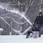 
              A man clears a driveway with a snowblower, Tuesday, Feb. 28, 2023, in Milton, N.H. Much of the area north of Boston received about two inches of snow before turning to rain from a winter storm. (AP Photo/Charles Krupa)
            
