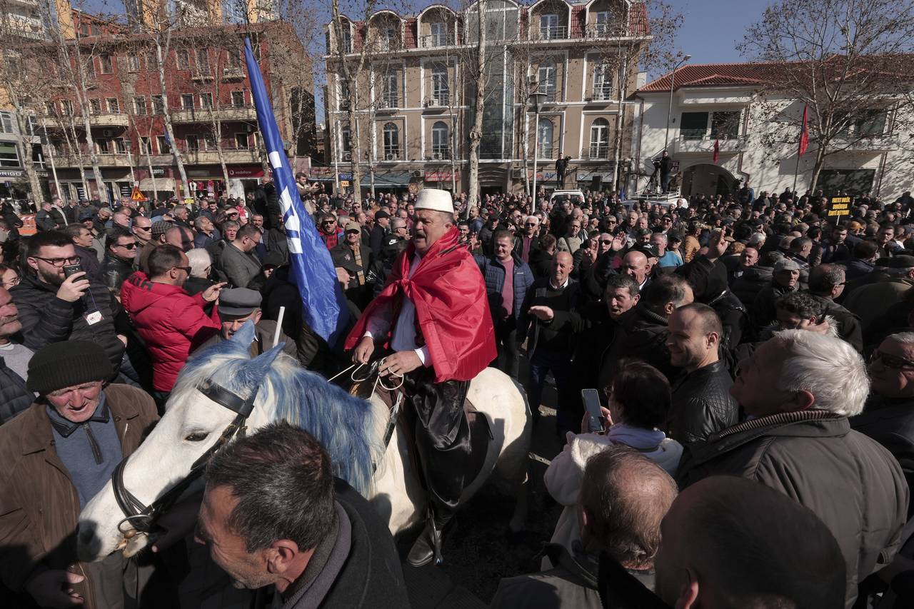 A man rides a horse during an anti-government rally outside the parliament in Tirana, Albania, Thur...