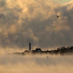 
              Arctic sea smoke rises from the Atlantic Ocean at Portland Head Light, Saturday, Feb. 4, 2023, in Cape Elizabeth, Maine. The morning temperature was about -10 degrees Fahrenheit. (AP Photo/Robert F. Bukaty)
            