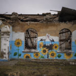 
              A painting decorates the façade of a house damaged during the Russian occupation in Bucha, near Kyiv, Ukraine, Friday, Feb. 17, 2023. (AP Photo/Emilio Morenatti)
            