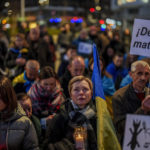 
              Ukrainian people take part in a protest marking one year since Russia's invasion of Ukraine at the Spain square in Madrid, Spain, Friday, Feb. 24, 2023. The banner reads in Spanish: "Stop killing us". (AP Photo/Manu Fernandez)
            