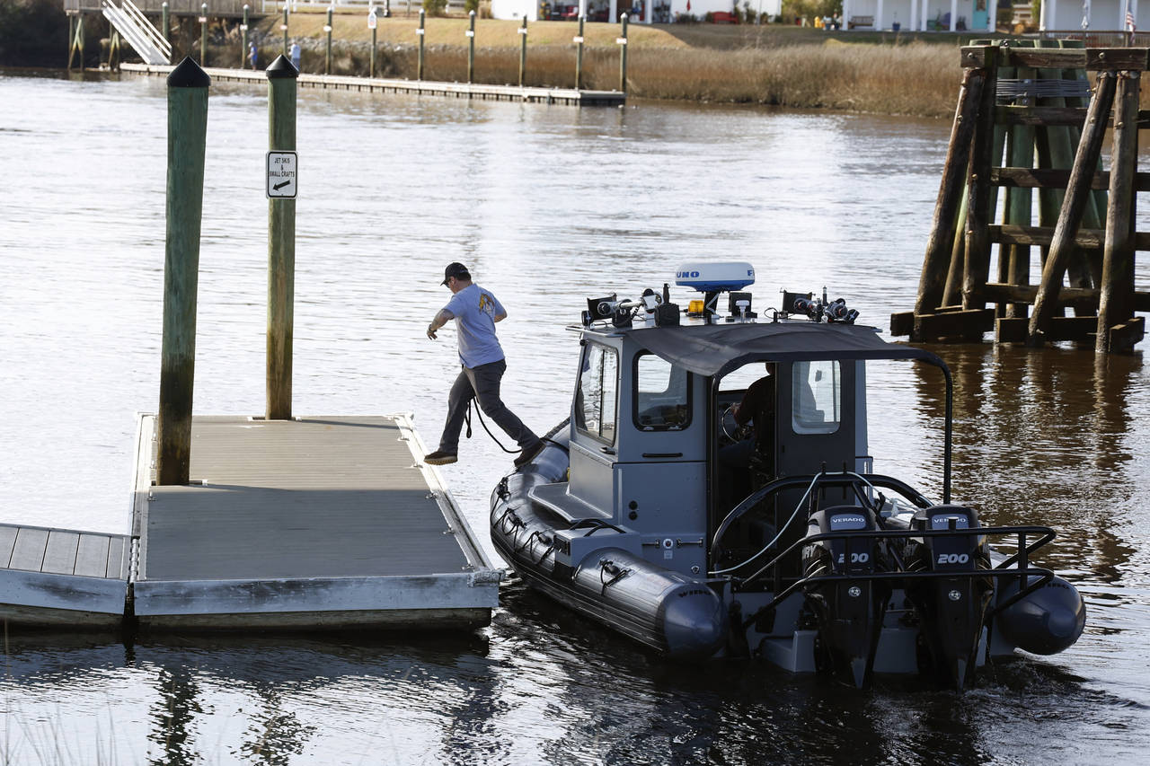 A man jumps from a Navy boat to secure it to a dock on the InterCoastal Waterway in North Myrtle Be...