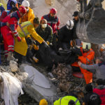 
              Emergency team members carry a body of a person found in the rubble of a destroyed building in Adana, Turkey, Tuesday, Feb. 7, 2023. Rescuers raced Tuesday to find survivors in the rubble of thousands of buildings brought down by a powerful earthquake and multiple aftershocks that struck eastern Turkey and neighboring Syria. (AP Photo/Francisco Seco)
            