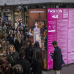 
              Visitors walk inside Milan's Fashion Hub, northern Italy, during the 2023/2024 fall-winter collection fashion week, Tuesday, Feb. 21, 2023. U.S.-based Blanc Magazine is promoting an inclusion initiative called Blanc Spaces and giving underrepresented, incredibly talented designers a place to be seen and heard. (Claudio Furlan/Lapresse via AP)
            