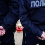 
              Serbian police officers stand by a cake with skull drop off in front of the Russian embassy building during a rally to mark the one-year anniversary of Russia's invasion of Ukraine in Belgrade, Serbia, Friday, Feb. 24, 2023. A traditional Slavic ally, Serbia has maintained friendly relations with Russia despite the invasion and has refused to join Western sanctions designed to punish Moscow for the aggression. (AP Photo/Darko Vojinovic)
            