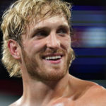 
              File - Social media personality Logan Paul stands in the ring before an exhibition boxing match, Sunday, June 6, 2021, in Miami Gardens, Fla. Three months after signing a contract with WWE last year, Paul took out a cell phone and filmed himself jumping from the ropes and onto wrestler Roman Reigns. (AP Photo/Lynne Sladky, File)
            