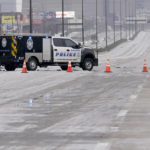 
              A City of Dallas emergency vehicle blocks lanes of U.S. Highway 75 during icy and slushy road conditions, Wednesday, Feb. 1, 2023, in Dallas. (AP Photo/Tony Gutierrez)
            