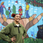 
              Kailani Taylor-Cribb stands in front of mural at a neighborhood community garden in Asheville, N.C., on Tuesday, Jan. 31, 2023. She knows, looking back, that things could have been different. While she has no regrets about leaving high school, she says she might have changed her mind if someone at school had shown more interest and personal attention to her needs. “All they had to do was take action,” she said. “There were so many times they could have done something. And they did nothing.” (AP Photo/Kathy Kmonicek)
            