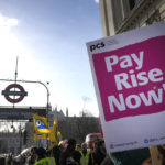 
              Civil servants hold banners as they protest in Westminster in London, Wednesday, Feb. 1, 2023. Thousands of schools in the U.K. closed some or all of their classrooms, train services were paralyzed and delays were expected at airports Wednesday in what’s shaping up to be the biggest day of industrial action Britain has seen in more than a decade, as unions step up pressure on the government to demand better pay amid a cost-of-living crisis. (AP Photo/Kirsty Wigglesworth)
            