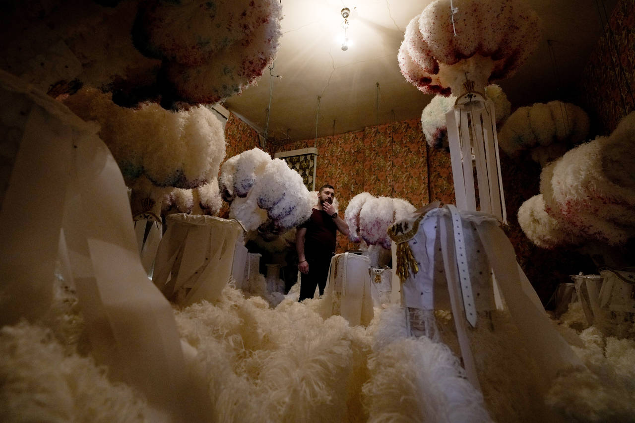 Quentin Kersten stands in the middle of a room full of ostrich feather hats in the Kersten family c...