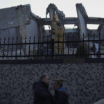 
              A man comforts a woman crying next to the destroyed Ronesans Residence 12-story building in Antakya, southern Turkey, Thursday, Feb. 9, 2023. Turkey has for years tempted fate by not enforcing modern construction codes while allowing, and in some cases, encouraging, a real estate boom in earthquake-prone areas, experts say. (AP Photo/Khalil Hamra)
            