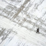 
              A man crosses a snow covered S. Sixth St. Wednesday, Feb. 22, 2023 in downtown Minneapolis. (Alex Kormann/Star Tribune via AP)
            