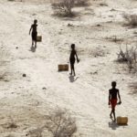 
              Young boys pull containers of water as they return to their huts from a well in the village of Ntabasi village amid a drought in Samburu East, Kenya, on Friday, Oct, 14, 2022. With the prospect of a sixth consecutive failed rainy season in the east and Horn of Africa, Kenya's president is hoping the heavens will finally open with the help of a national day of mass prayer on Tuesday, Feb. 14, 2023. (AP Photo/Brian Inganga)
            