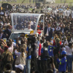 
              Pope Francis on the popemobile arrives at Ndolo airport where he will preside over the Holy Mass in Kinshasa, Congo, Wednesday Feb. 1, 2023. Francis is in Congo and South Sudan for a six-day trip, hoping to bring comfort and encouragement to two countries that have been riven by poverty, conflicts and what he calls a "colonialist mentality" that has exploited Africa for centuries. (AP Photo/Gregorio Borgia)
            