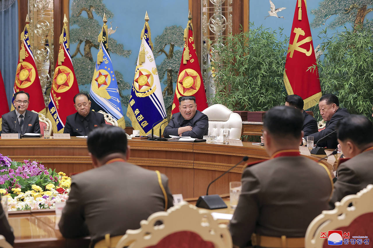 In this photo provided by the North Korean government, North Korean leader Kim Jong Un, center, att...