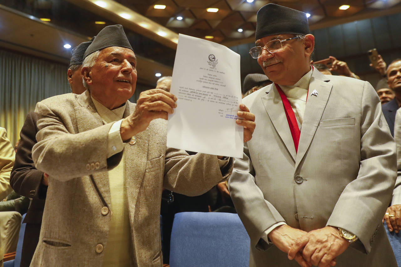 Nepalese Prime Minister Pushpa Kamal Dahal, right, looks on as Ram Chandra Poudel of the Nepali Con...