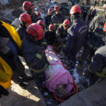 
              Rescue teams evacuate a survivor from the rubble of a destroyed building in Kahramanmaras, southern Turkey, Tuesday, Feb. 7, 2023. A powerful earthquake hit southeast Turkey and Syria early Monday, toppling hundreds of buildings and killing and injuring thousands of people. (AP Photo/Khalil Hamra)
            