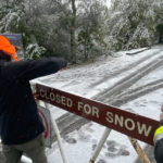 
              A parks worker puts up a closed sign at the entrance to Mount Tamalpais State Park in Mill Valley, Calif., Friday Feb. 24, 2023. California and other parts of the West are facing heavy snow and rain from the latest winter storm to pound the United States. The National Weather Service has issued blizzard warnings for the Sierra Nevada and Southern California mountains. (AP Photo/Haven Daley)
            