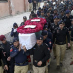 
              Police officers carry the casket of a fellow police officer, a victim of Monday's suicide bombing, for his funeral in Peshawar, Pakistan, Feb. 2, 2023. A suicide bomber who killed 101 people at a mosque in northwest Pakistan this week had disguised himself in a police uniform and did not raise suspicion among guards, the provincial police chief said on Thursday. (AP Photo/Muhammad Sajjad)
            