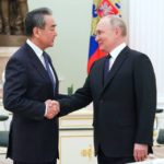 
              Russian President Vladimir Putin greets Chinese Communist Party's foreign policy chief Wang Yi during their meeting at the Kremlin in Moscow, Russia, Wednesday, Feb. 22, 2023. (Anton Novoderezhkin, Sputnik, Kremlin Pool Photo via AP)
            