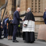 
              Leader of the federal opposition, Peter Dutton, center right, arrives at St. Mary's Cathedral before the funeral and interment of polarizing Cardinal George Pell in Sydney, Thursday, Feb. 2, 2023. Pell, who died last month at age 81, spent more than a year in prison before his sex abuse convictions were overturned in 2020. (AP Photo/Rick Rycroft)
            