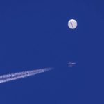 
              FILE - In this photo provided by Chad Fish, a large balloon drifts above the Atlantic Ocean, just off the coast of South Carolina, with a fighter jet and its contrail seen below it, Saturday, Feb. 4, 2023. U.S. officials say the military has finished efforts to recover the remnants of the large balloon that was shot down off the coast of South Carolina, and analysis of the debris so far reinforces conclusions that it was a Chinese spy balloon.  (Chad Fish via AP, File)
            