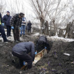 
              EDS NOTE: GRAPHIC CONTENT - An excavator exhumes the grave of Svitlana Shabanova, who was killed by Russian forces during evacuation on April 14, 2022 and buried at the territory of a hospital in the liberated town of Borova, Kharkiv region, Ukraine, on Wednesday, Feb. 1, 2023. The police and the war crimes prosecutor's office conducted an exhumation of local residents who were killed by Russian soldiers during their evacuation by two minivans on April 14, 2022.(AP Photo/Andrii Marienko)
            