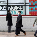 
              People wearing protective masks walk past an electronic stock board showing Japan's Nikkei 225 index at a securities firm Monday, Feb. 20, 2023, in Tokyo. Shares were mostly higher in Asia on Monday after Wall Street closed out another bumpy week with a mixed performance. (AP Photo/Eugene Hoshiko)
            