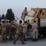 
              Troops load aid onto a vehicle as U.S. Secretary of State Antony Blinken visits Incirlik Air Base near Adana, Turkey, Sunday, Feb. 19, 2023. (Clodagh Kilcoyne/Pool Photo via AP)
            