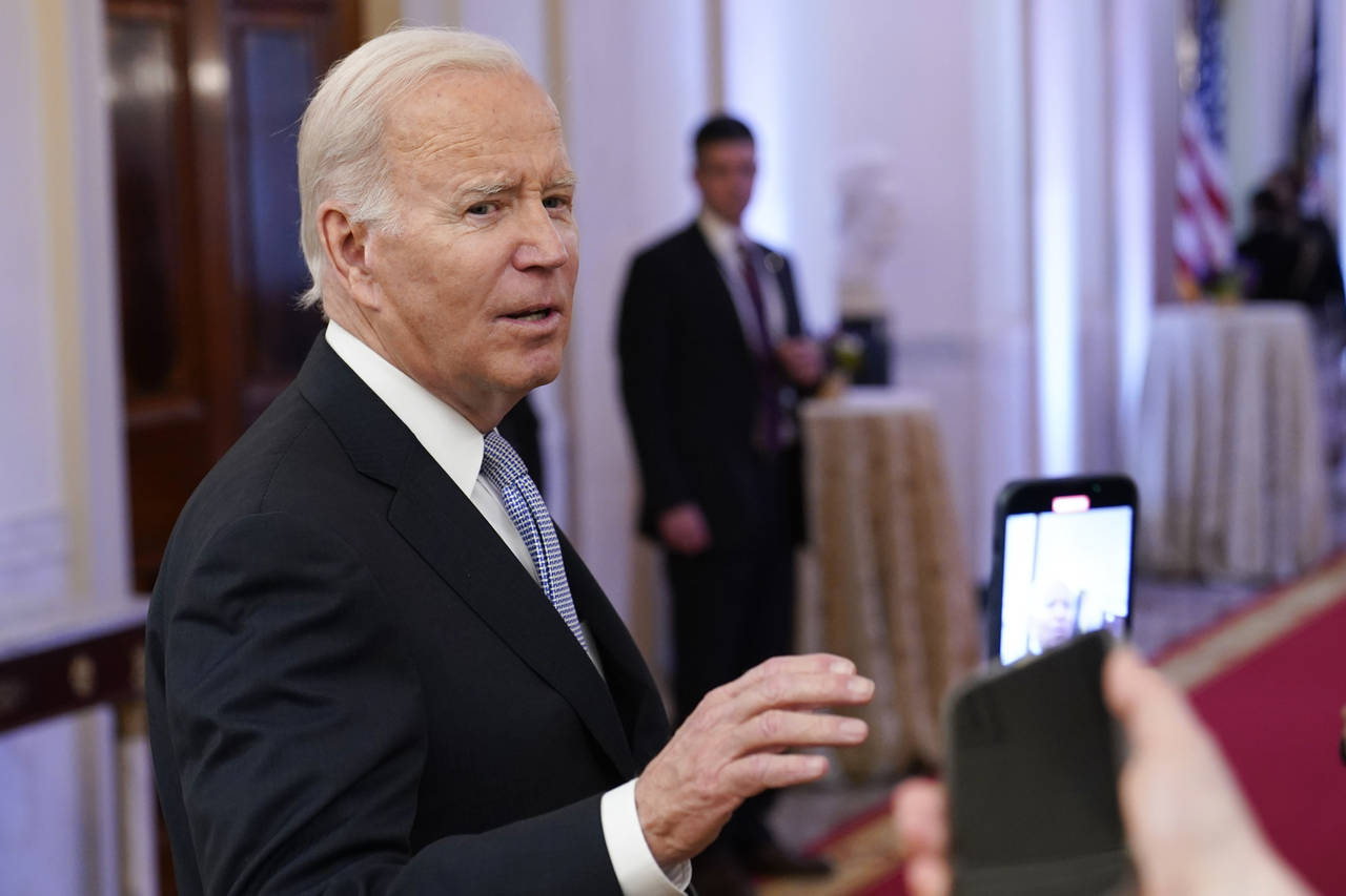 FILE - President Joe Biden talks with reporters after speaking in the East Room of the White House ...