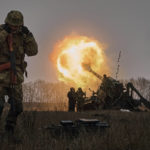 FILE - Ukrainian soldiers fire a Pion artillery system at Russian positions near Bakhmut, Donetsk region, Ukraine, Friday, Dec. 16, 2022. As milestones go, the first anniversary of Russia's invasion of Ukraine is both grim and vexing. It marks a full year of killing, destruction, loss and pain felt even beyond the borders of Russia and Ukraine.  (AP Photo/LIBKOS, File)