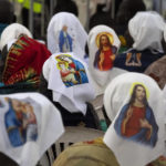 
              Nuns wear headwear showing the Virgin Mary and Jesus Christ as they await the arrival of Pope Francis for a Holy Mass at the John Garang Mausoleum in Juba, South Sudan Sunday, Feb. 5, 2023. Pope Francis is in South Sudan on the final day of a six-day trip that started in Congo, hoping to bring comfort and encouragement to two countries that have been riven by poverty, conflicts and what he calls a "colonialist mentality" that has exploited Africa for centuries. (AP Photo/Ben Curtis)
            