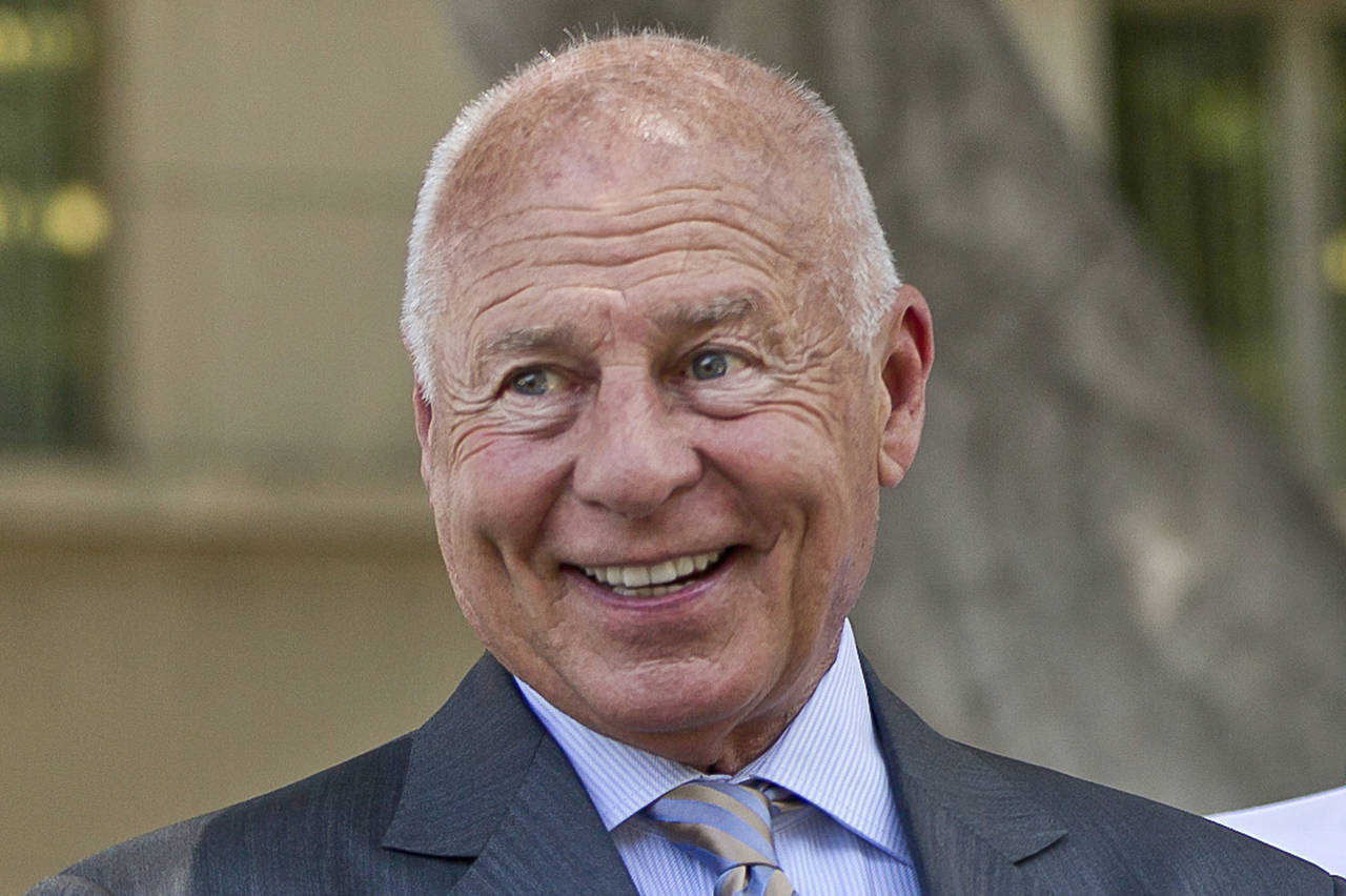 FILE - Attorney Tom Girardi smiles outside the Los Angeles courthouse on Wednesday, July 9, 2014. D...