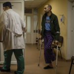 
              Landmine victim Oleksandr Kolisnyk follows Ukrainian doctor Yurii Kuznetsov in his office at the hospital in Izium, Ukraine, Sunday, Feb. 18, 2023. Russian attacks have devastated Ukraine's health care system, raining down explosions upon hospitals and ambulances at a rate of nearly two a day for the past year, according to a study that attempted to document each strike.(AP Photo/Vadim Ghirda)
            