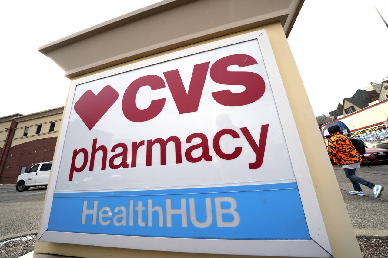 A CVS store sign is displayed in Pittsburgh on Friday, Feb. 3, 2023. CVS Health is plunging deeper ...