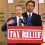 
              Speaker of the Florida House of Representatives Paul Renner, left, speaks during a press conference that Florida Governor Ron DeSantis, back, held to announce family-focused tax relief for Florida residents, Wednesday, Feb. 8, 2023, in Ocala, Fla. DeSantis spoke about Disney and how they will be no longer self governing "because there's a new sheriff in town." (Doug Engle/Ocala Star-Banner via AP)
            