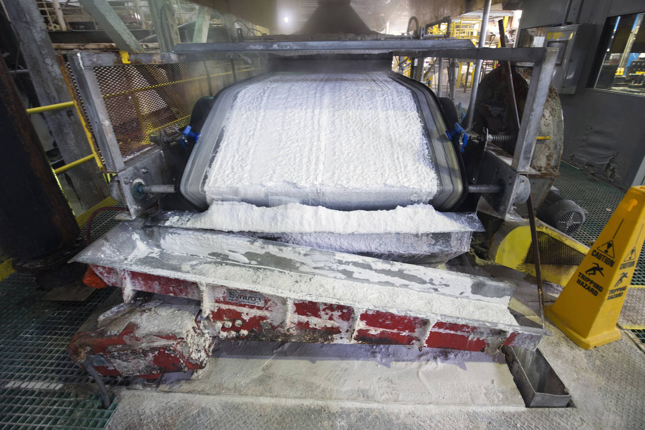 FILE - Technical grade lithium carbonate comes off a conveyor belt during a tour of the Silver Peak...