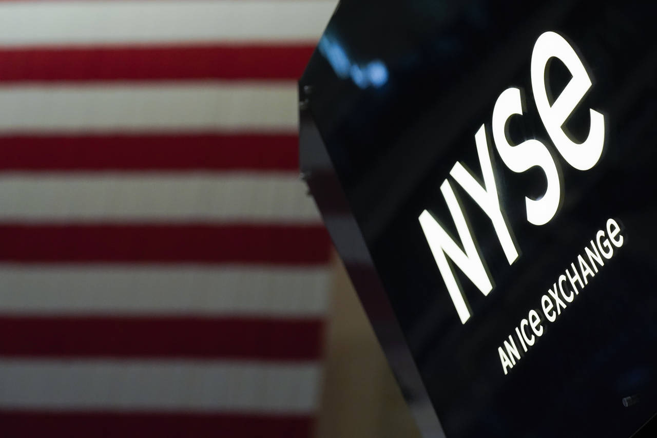 FILE - An NYSE sign is seen on the floor at the New York Stock Exchange in New York, Wednesday, Jun...