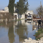
              A car drives through the al-Tlul village flooded after a devastating earthquake destroyed a river dam in the town of Salqeen near the Turkish border, Idlib province, Syria, Thursday, Feb. 9, 2023.  (AP Photo/Ghaith Alsayed)
            