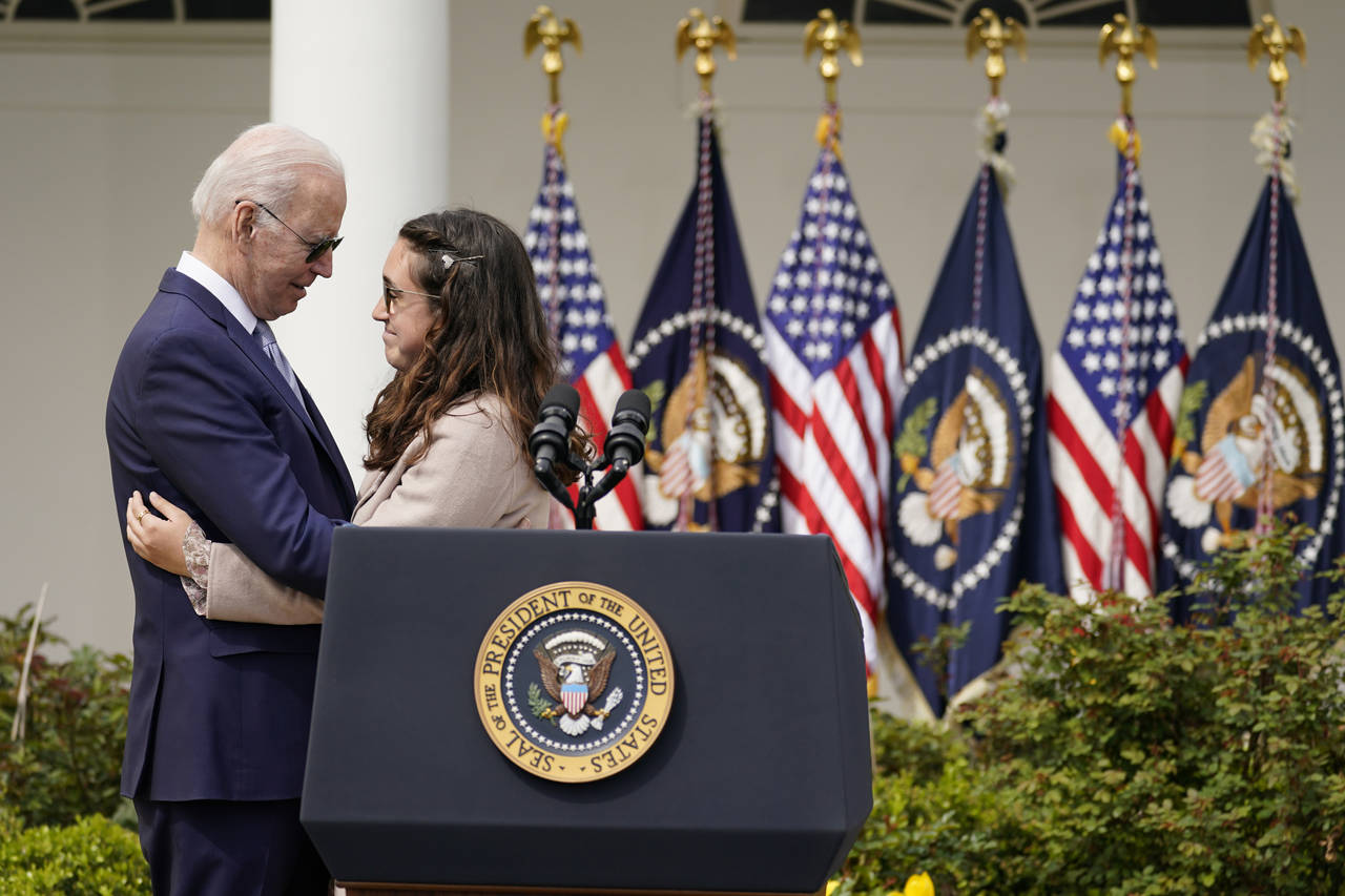 FILE - President Joe Biden hugs Mia Tretta, a survivor of the Saugus High School shooting in Santa ...