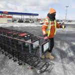 
              Giant Eagle grocery store employee Cordell Lewis gathers shopping carts in the bitter cold, Friday, Feb. 3, 2023, in Johnstown, Pa. (Todd Berkey/The Tribune-Democrat via AP)
            