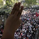 
              Myanmar nationals living in Thailand display the three-finger symbol of resistance during a protest marking the two-year anniversary of the military takeover that ousted her government outside the Myanmar Embassy in Bangkok, Thailand, Wednesday, Feb. 1, 2023. (AP Photo/Sakchai Lalit)
            