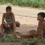 
              Yanomami women sit with their babies outside the Health Indigenous House, a center responsible for supporting and assisting Indigenous people, in Boa Vista, Roraima state, Brazil Wednesday, Feb. 8, 2023. (AP Photo/Edmar Barros)
            