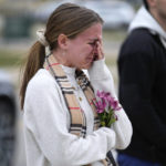 
              A student cries where flowers are being left at the Spartan Statue on the grounds of Michigan State University, in East Lansing, Mich., Tuesday, Feb. 14, 2023. A gunman killed several people and wounded others at Michigan State University. Police said early Tuesday that the shooter eventually killed himself. (AP Photo/Paul Sancya)
            