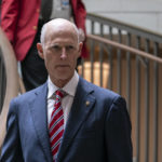 
              FILE - Sen. Rick Scott, R-Fla., heads to a classified briefing on China, at the Capitol in Washington, Feb. 15, 2023. Last year, Scott, laid out a plan to require Congress to reconsider all federal laws every five years — leading to criticism by President Joe Biden that Social Security and Medicare would be cut. After several months of flak, Scott on Friday revised his plan to specifically exclude Social Security and Medicare. (AP Photo/J. Scott Applewhite, File)
            